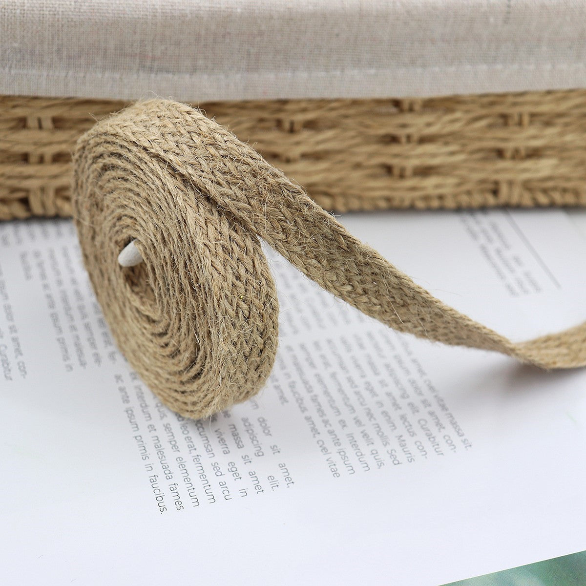 Hemp ribbon roll and loose ribbon end, natural twill weave texture
