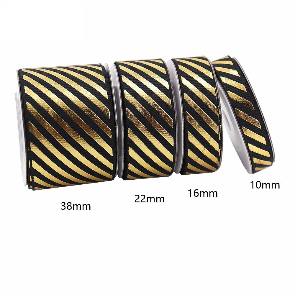 Black-and-gold diagonal stripe grosgrain ribbon with foil accent, widths 10/16/22/38mm