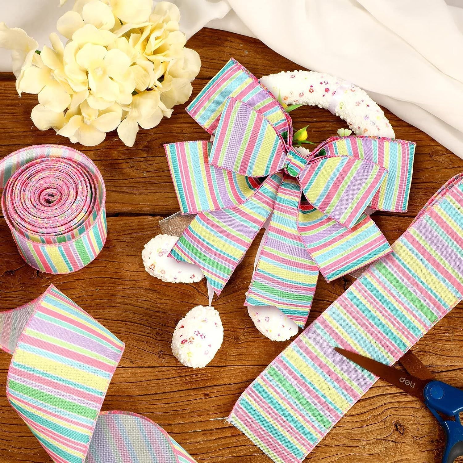 Pastel striped wired-edge ribbon bow and loose ribbon loops with matching roll