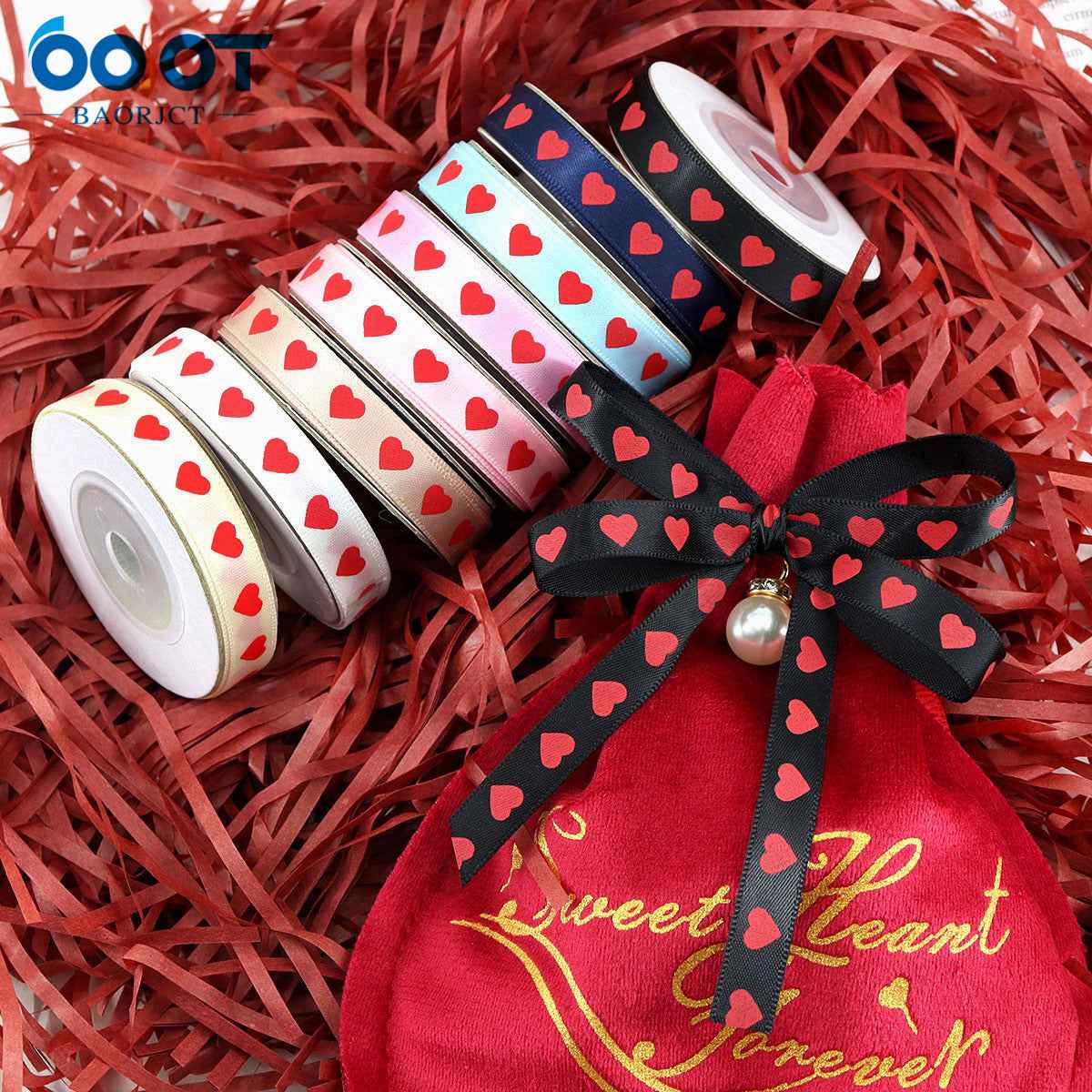 Red gift bow with black ribbon featuring red hearts and a small pearl center