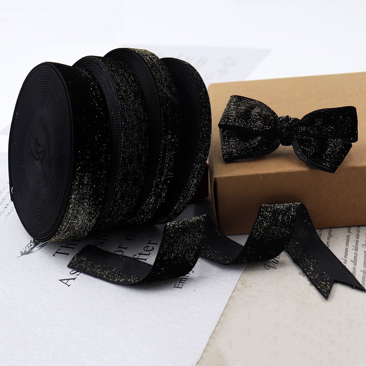 Rolled black velvet ribbon with gold edge and matching bow