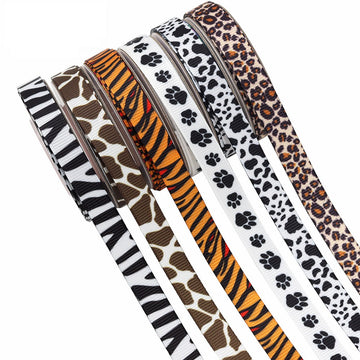 Animal print ribbon rolls (zebra, cow, leopard, giraffe, paw) in black, white, brown, orange