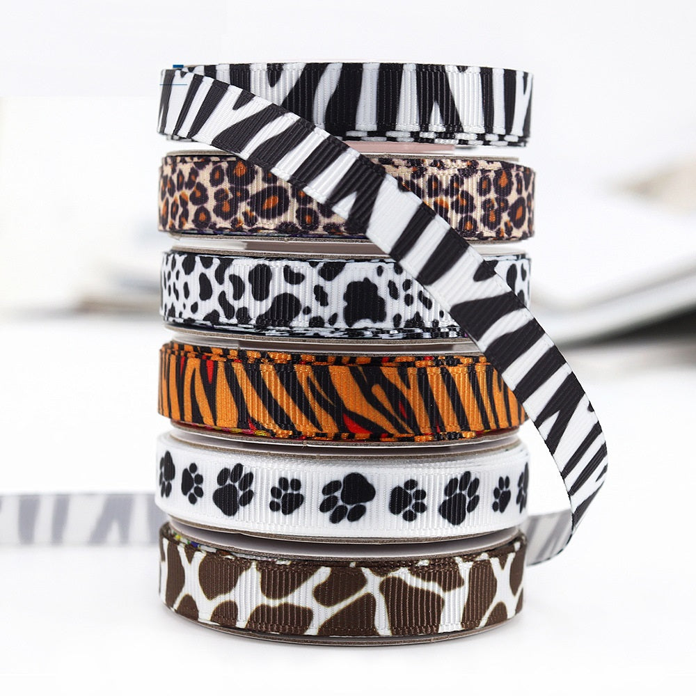Stacked animal print ribbons: zebra stripes, leopard spots, paw prints, cow pattern