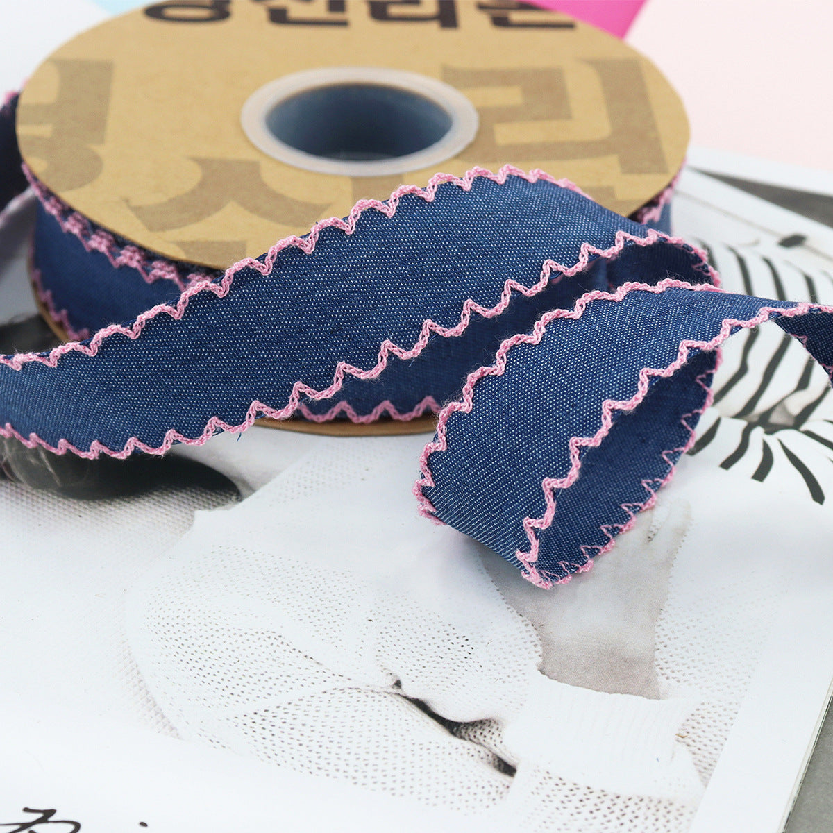 1.5-inch dark denim lace-edged ribbon with pink stitched zigzag trim