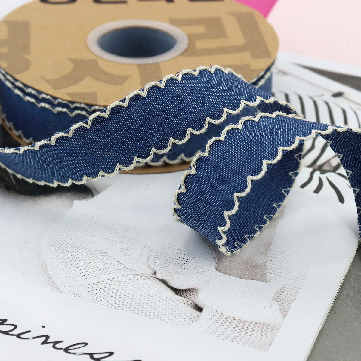 1.5-inch dark denim lace-edged ribbon with white stitched zigzag trim