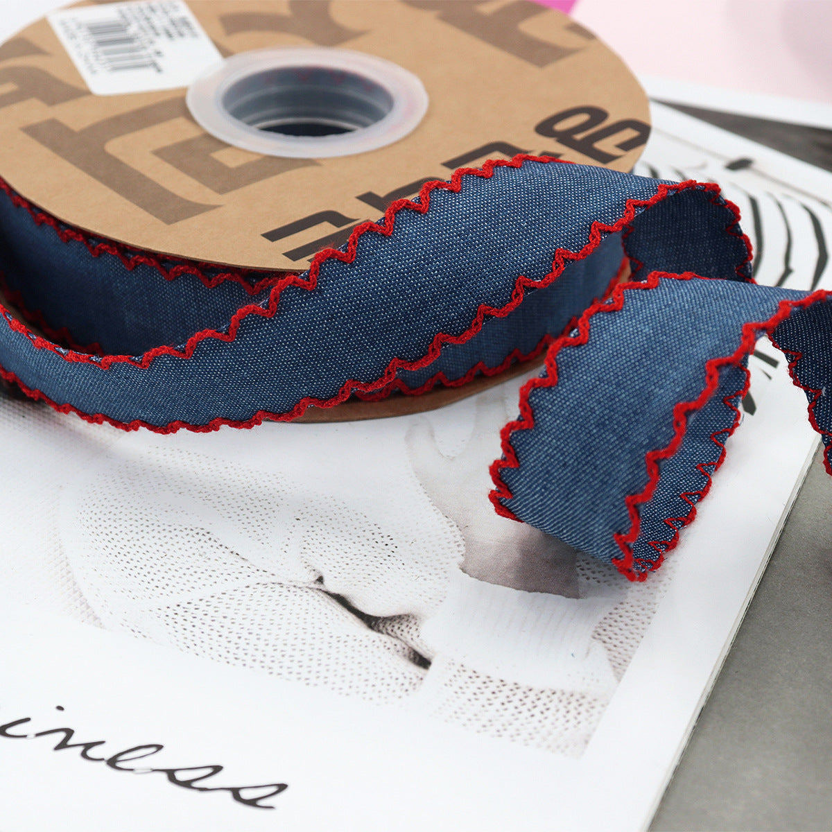 1.5-inch dark denim lace-edged ribbon with red stitched zigzag trim