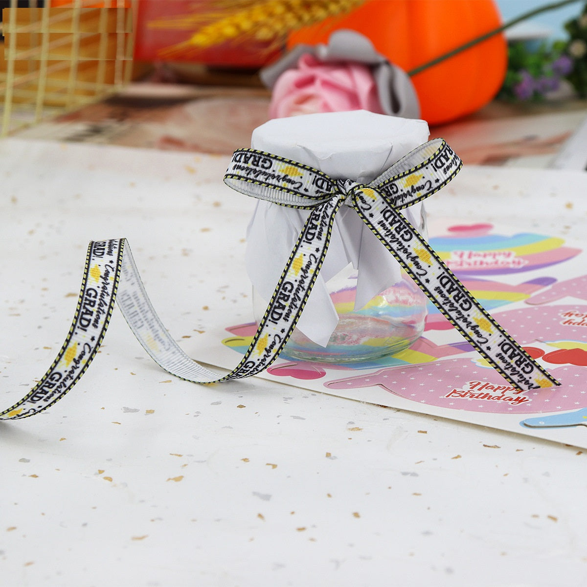 Black-and-white “Congratulations Grad” ribbon tied in a bow on a gift package