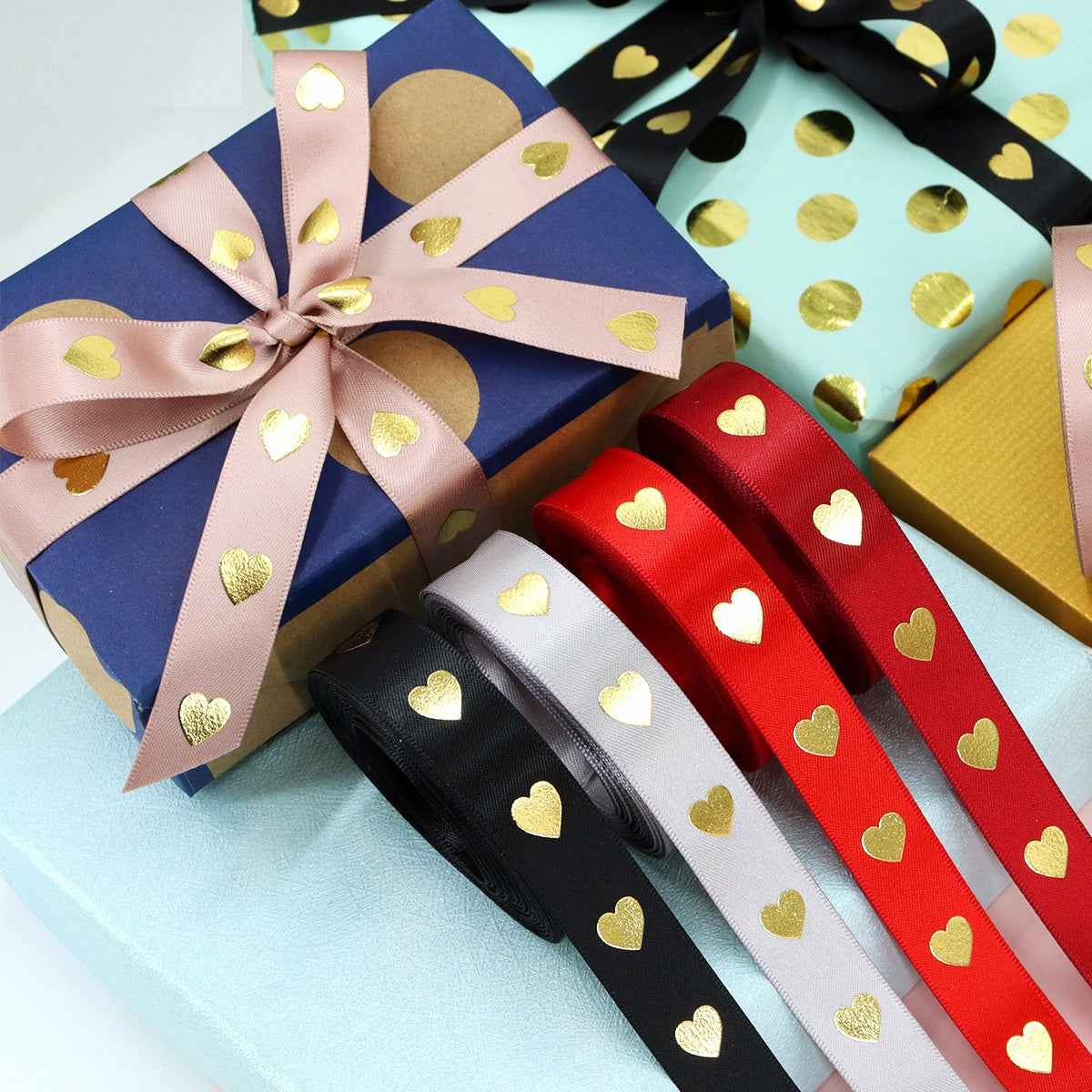 Ribbon set with gold hearts in red, white, black, pink—wrapped into gift bows