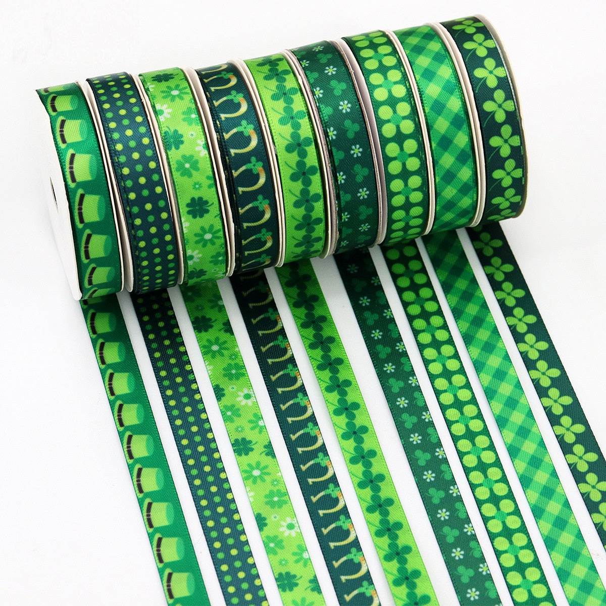 Rolled green ribbon strip with clover, grid, dots and stripe patterns
