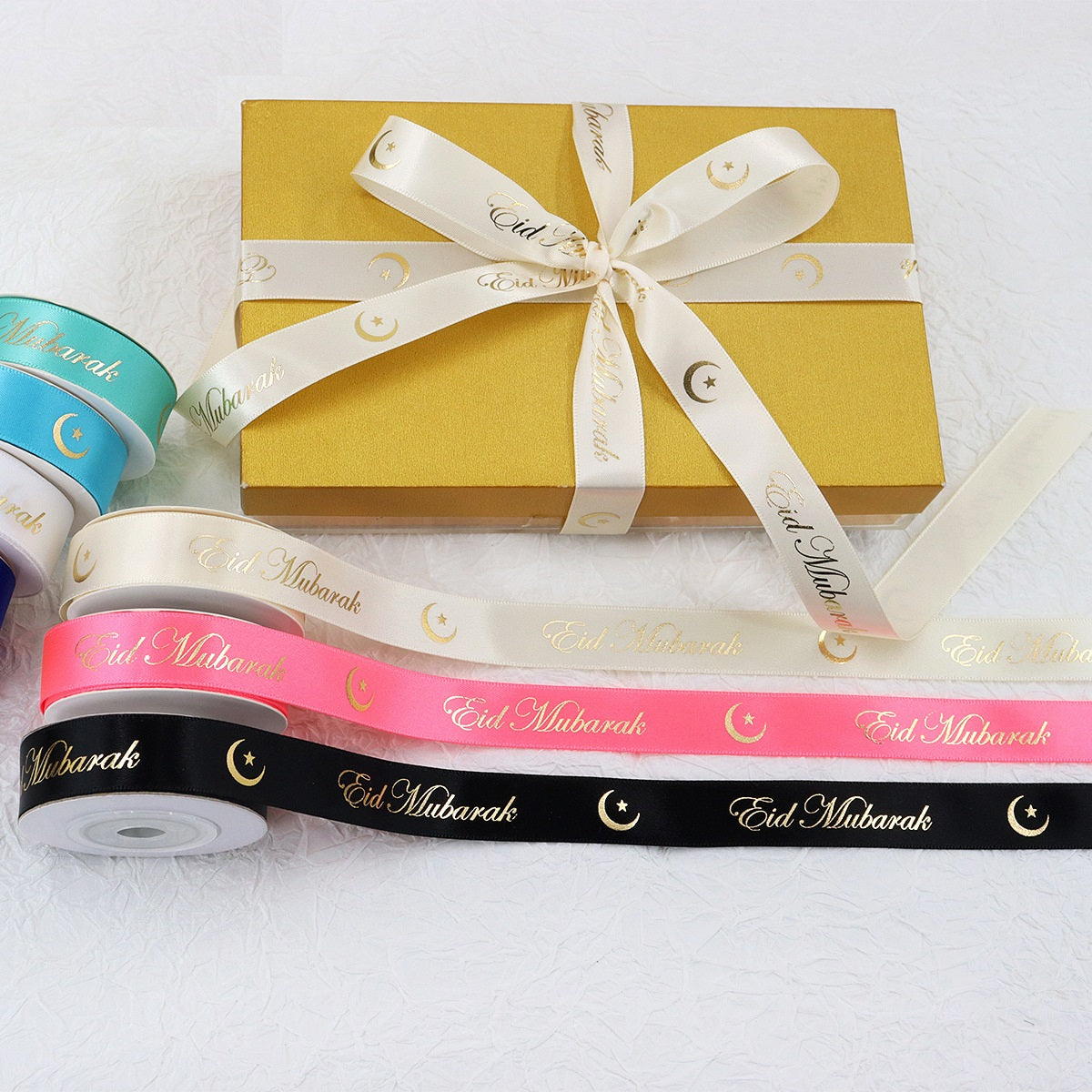 Hanukkah festive ribbon on rolls with gold “Eid Mubarak” text; pink and black ribbon highlighted