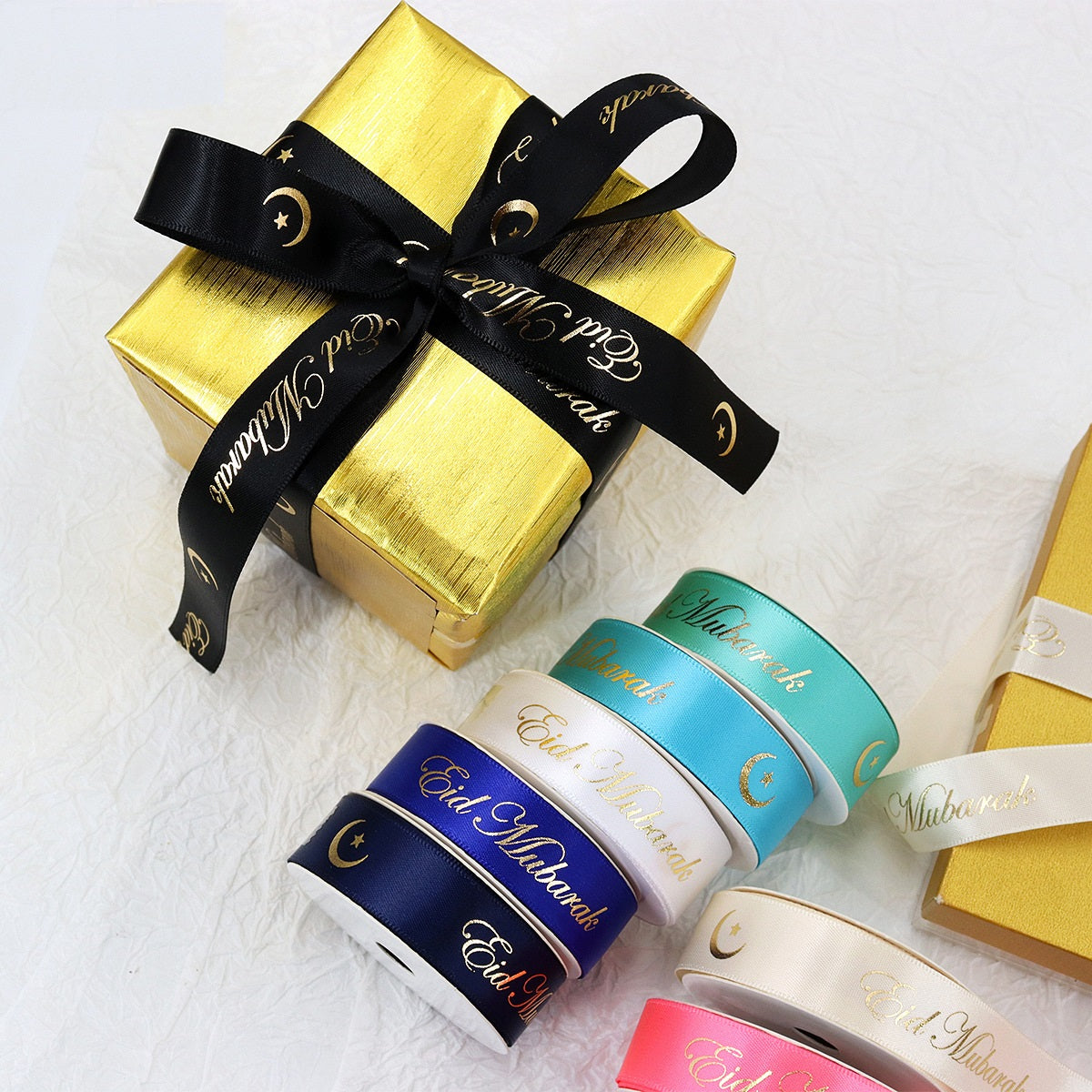 Hanukkah gift ribbons with gold “Eid Mubarak” on satin rolls, gold black teal and navy colors