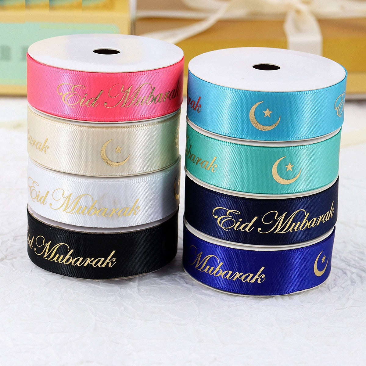 Hanukkah festive ribbons on rolls: pink, white, mint, teal, navy, each with gold “Eid Mubarak”