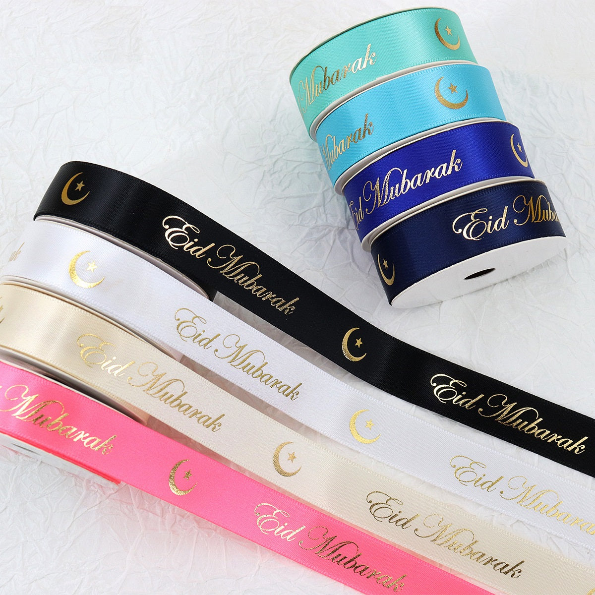Hanukkah festive ribbon rolls: black, white, pink, and cream with gold “Eid Mubarak” and crescents