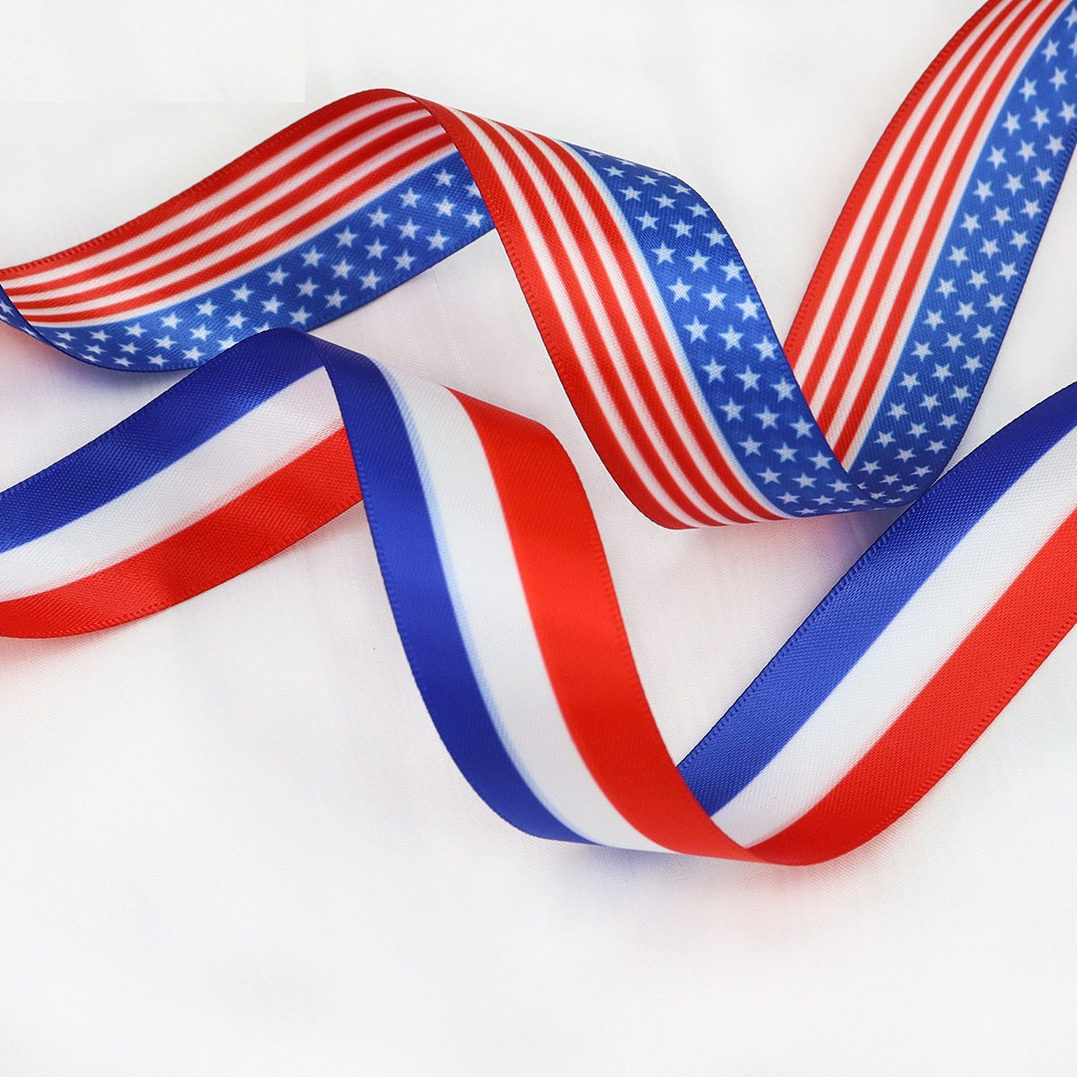 American flag ribbon with flowing red, white, blue stripes and blue star section