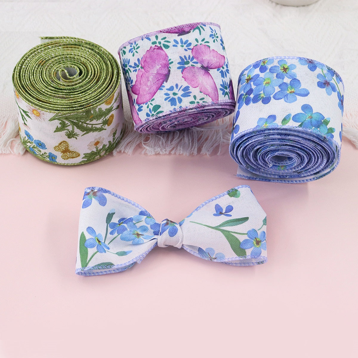 Ribbon rolls with floral prints in green, purple, and blue, 2.5 in wide