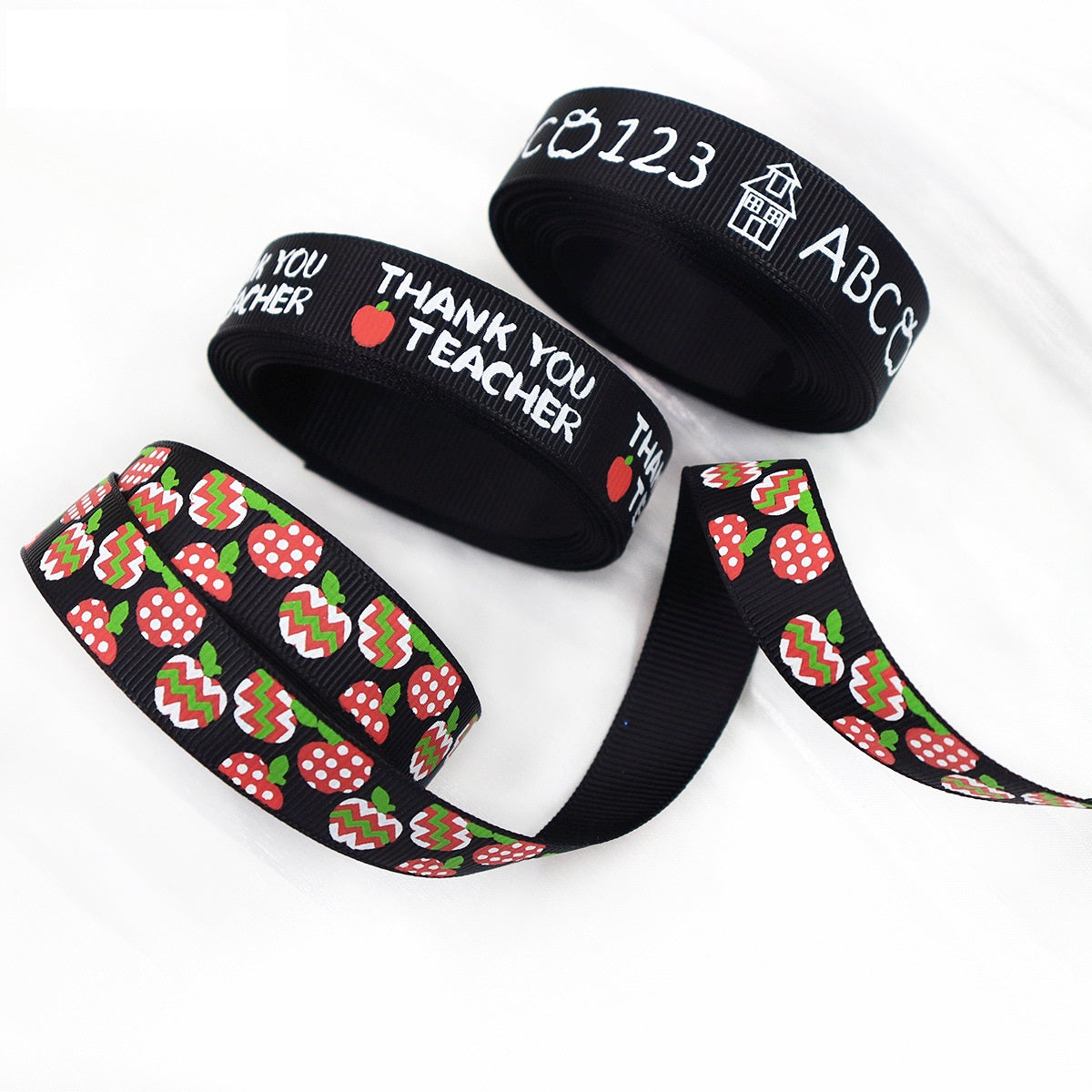 Black school ribbon with “Thank you Teacher” text and apple/zigzag pattern strip