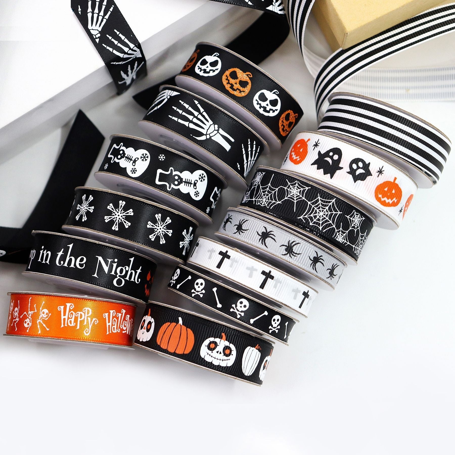 Set of Halloween ribbons on rolls: “Happy Halloween”, pumpkins, skulls, bats and stripes.