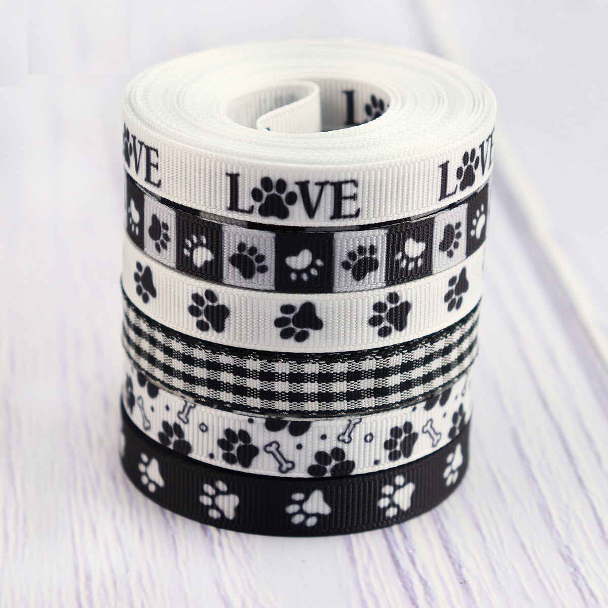 Rolled 10mm ribbon webbing with LOVE text and paw prints in black-and-white