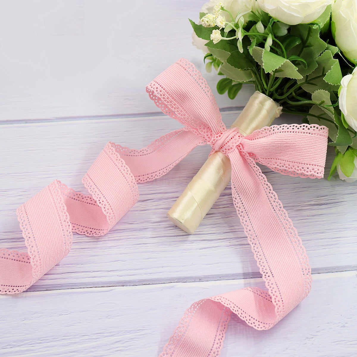 Pink 1.5 inch velvet ribbon with lace edge tied into a bow