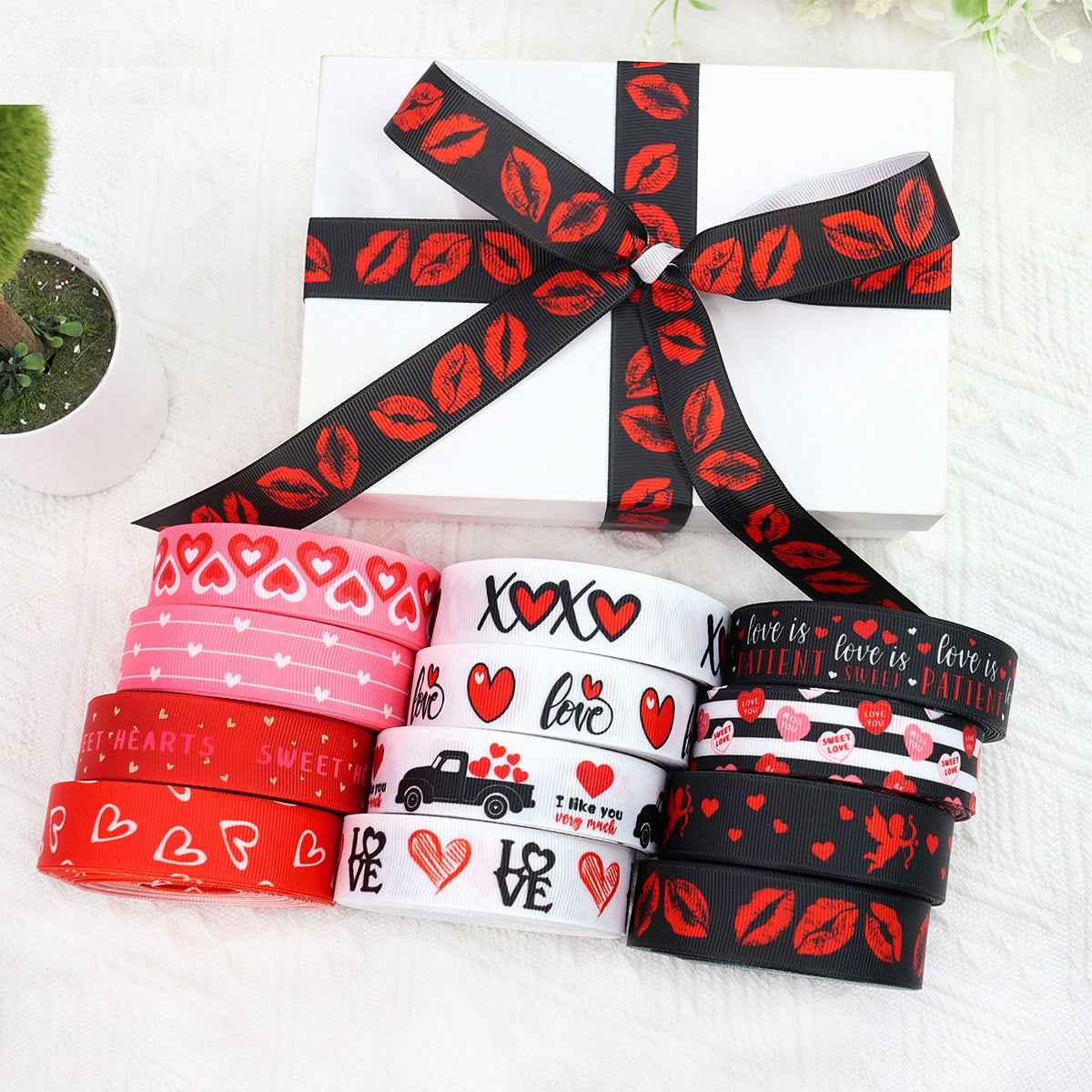 Ribbon rolls in red, black, and white with hearts and lips patterns; tied bow included