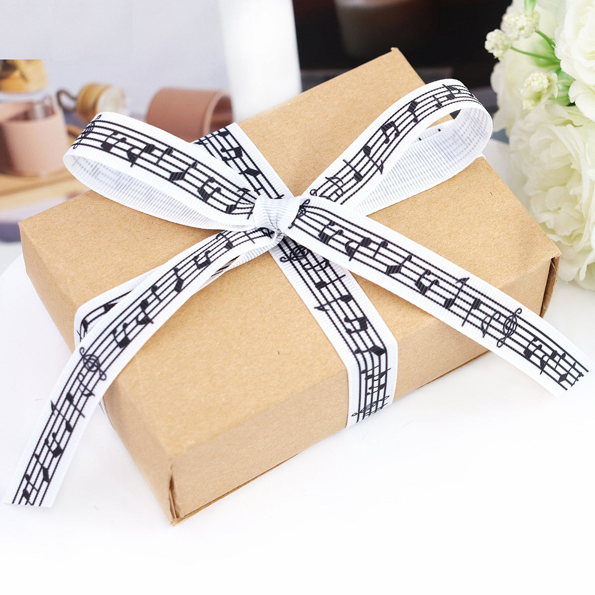 Black-and-white music note ribbon tied into a bow, 16 mm wide