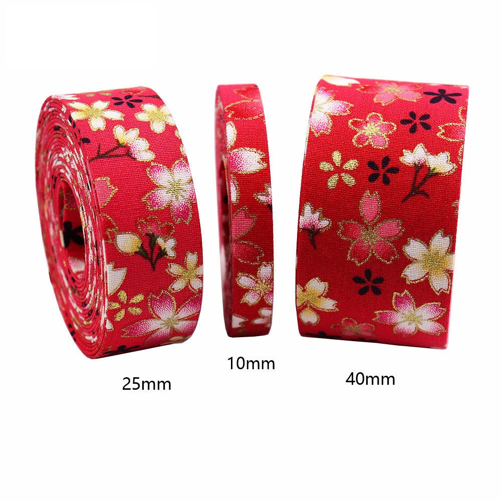 Sakura water ripple ribbon with gold floral on red fabric; widths labeled 10mm/25mm/40mm.