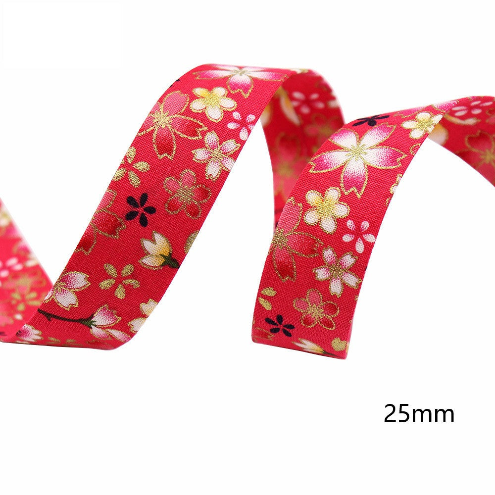 Sakura water ripple ribbon, 25mm width; red fabric with gold and white blossoms.