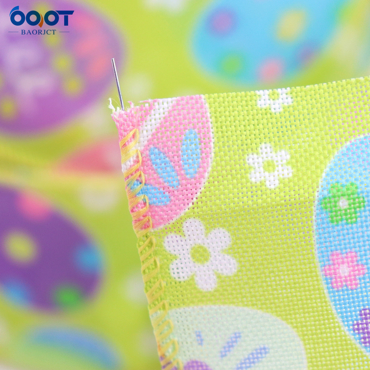 Wire-edged Easter ribbon close-up, pastel green with eggs, flowers and stitched edge