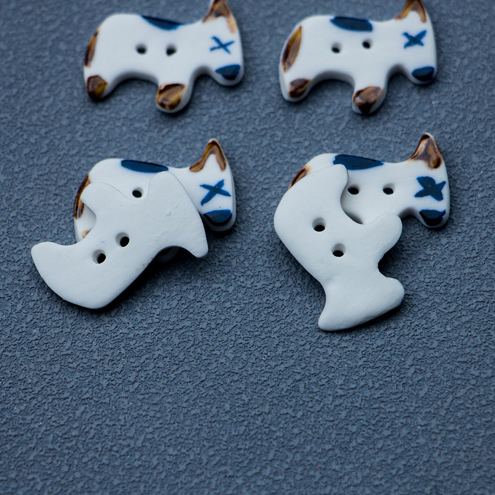 Ceramic puppy dog buttons, white with blue markings and two holes, 4 pcs shown