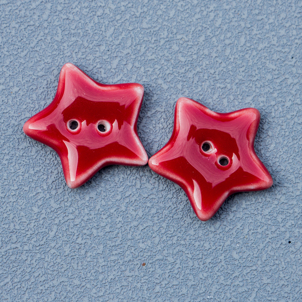 Red ceramic star button with two holes, glossy finish for handmade jewelry