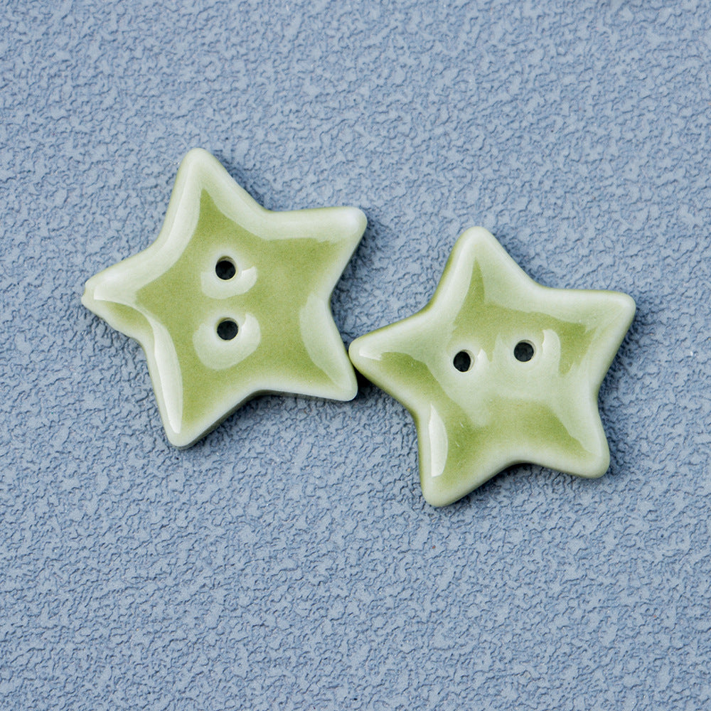 Light khaki-green ceramic star button with two holes, glossy surface