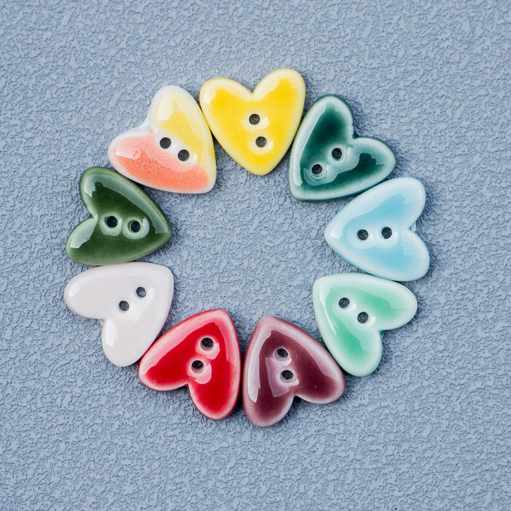 Assorted heart-shaped 2-hole ceramic buttons in red, yellow, green, blue, white