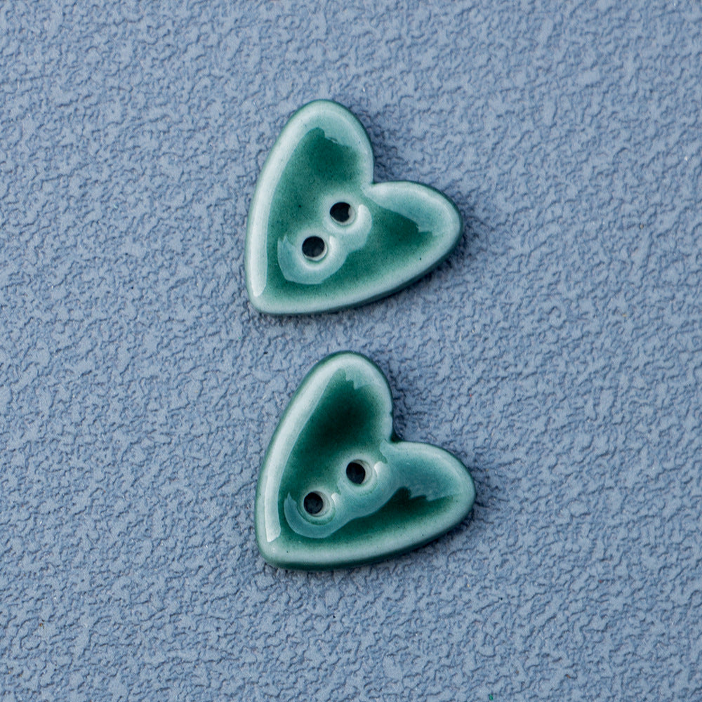 Dark green heart-shaped 2-hole ceramic buttons pair with two holes