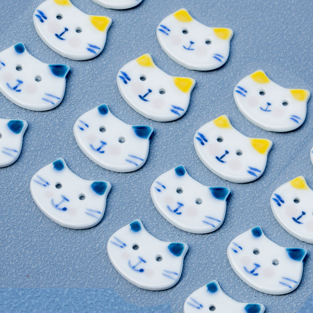 Set of small hand-painted ceramic cat buttons, blue whiskers, 2 holes