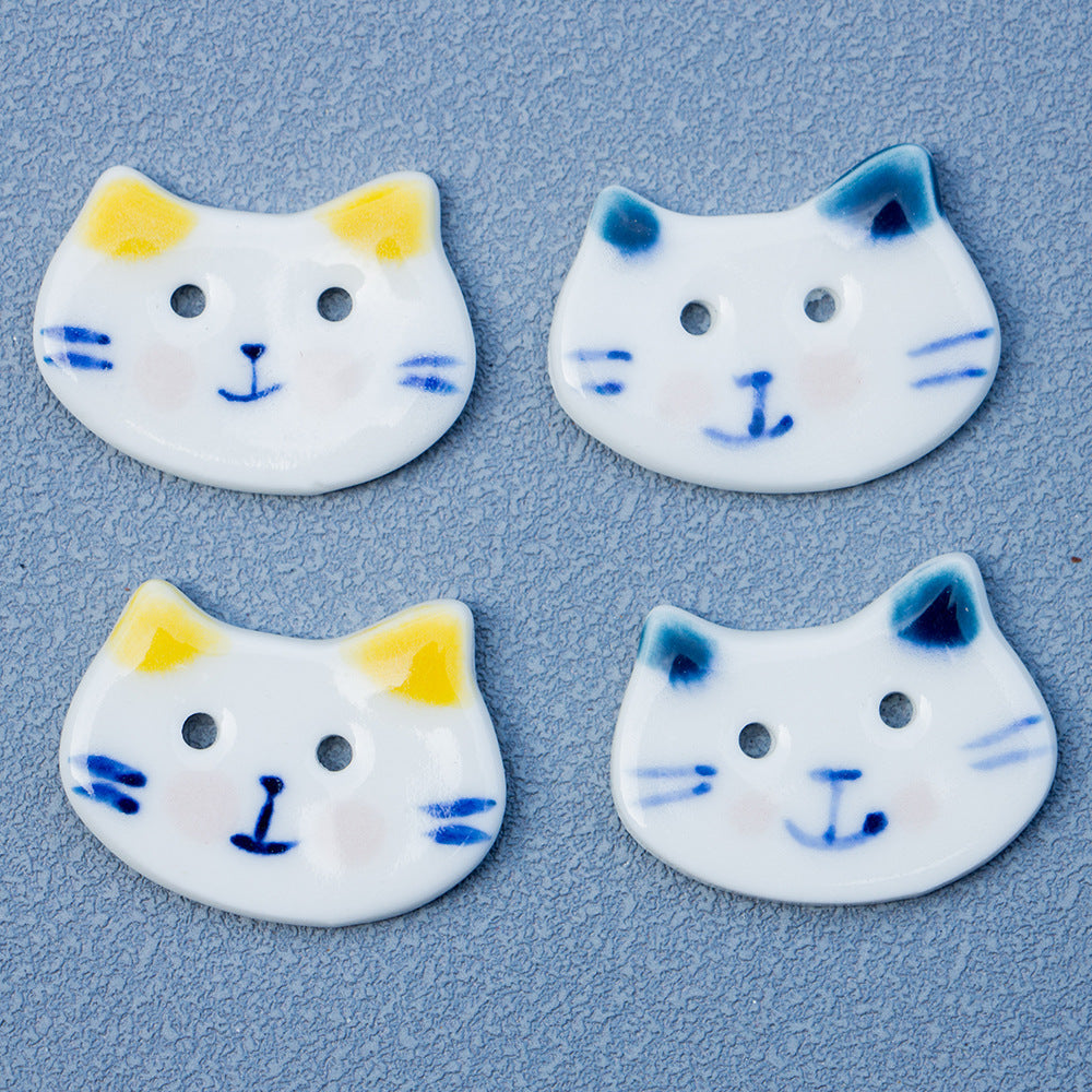 Hand-painted ceramic cat buttons, white base with yellow ears and 2 holes