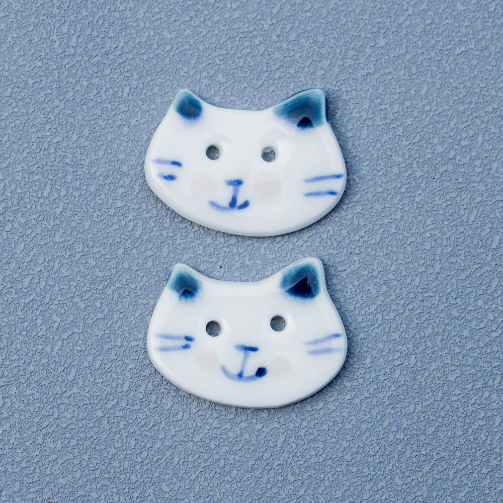 Two blue-eared cat ceramic buttons, white glaze with 2 holes