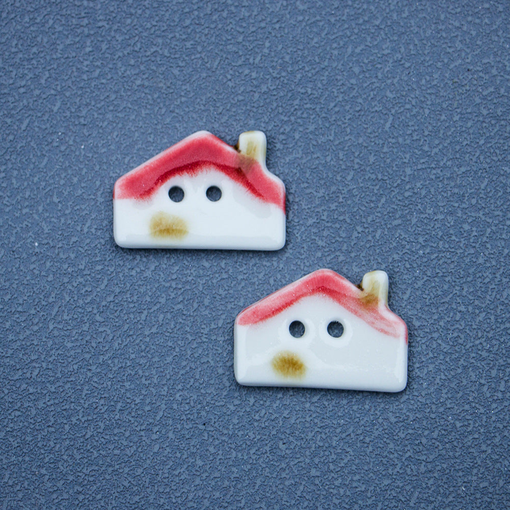 Dos botones cerámicos casita, techo rojo, base blanca y detalle amarillo, 2 agujeros.