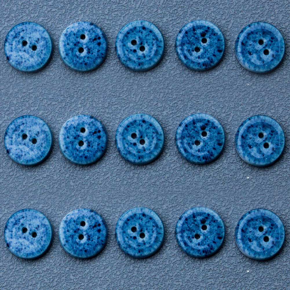 Deep blue round ceramic buttons with two holes, arranged in rows