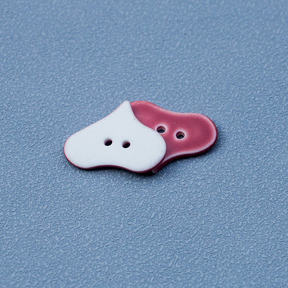 Red heart buttons with 2 holes; one shows lighter back