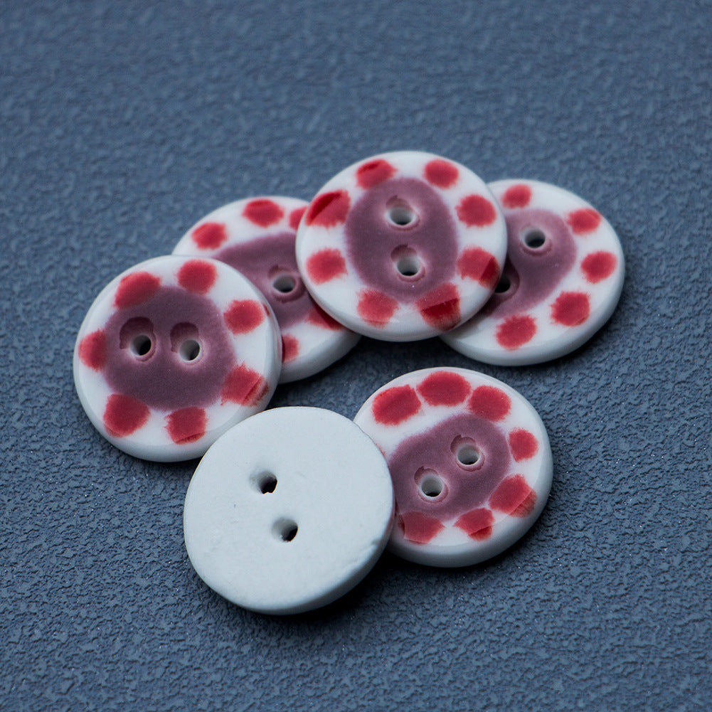 Set of round ceramic buttons with red-dotted pig motifs and two button holes