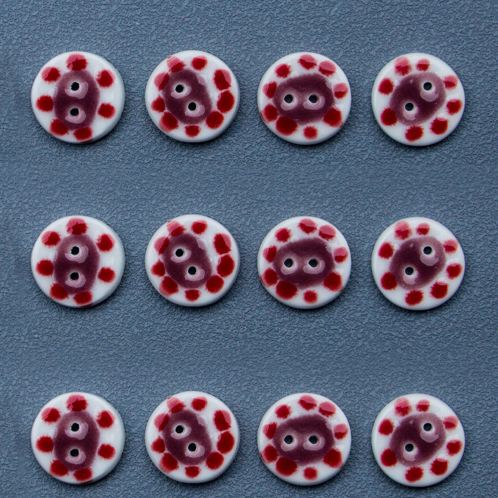 Assorted round ceramic buttons with red-dotted pig faces; each has 2 holes