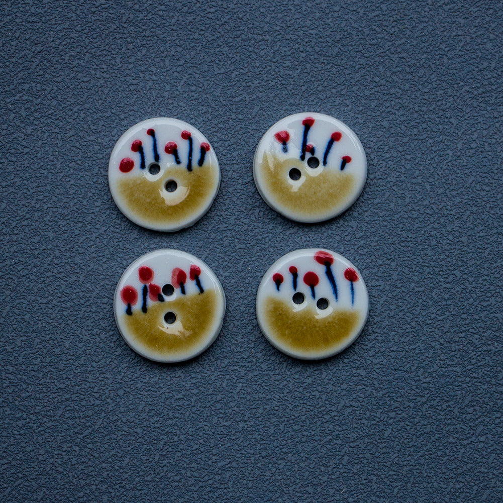 Two-hole ceramic buttons in tea yellow with small red flower design
