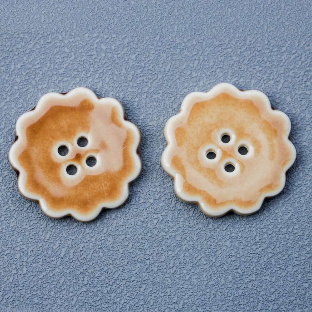 30mm round ceramic buttons, four-hole, khaki lace-edged, pair close-up