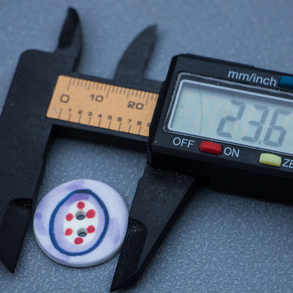 24mm two-hole porcelain button, light purple, blue ring, red dots; caliper measurement