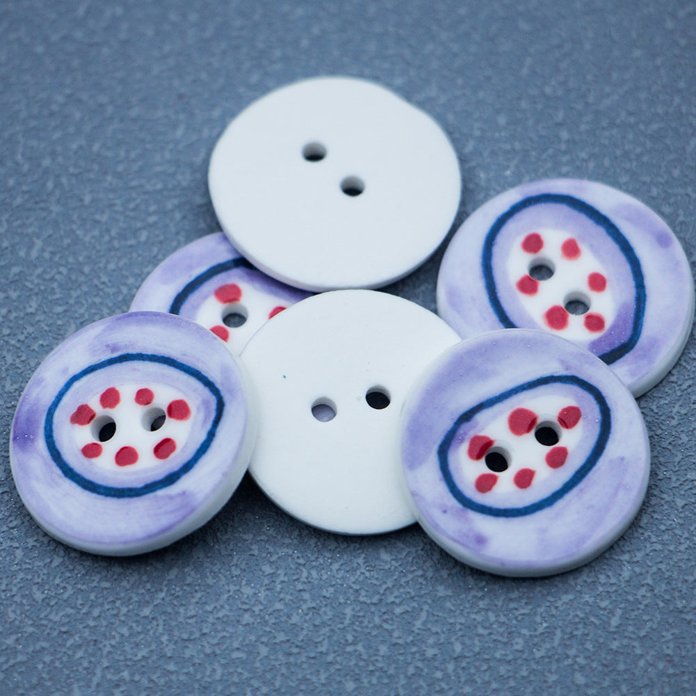 Set of four 24mm two-hole porcelain buttons, light purple, blue ring, red dot pattern