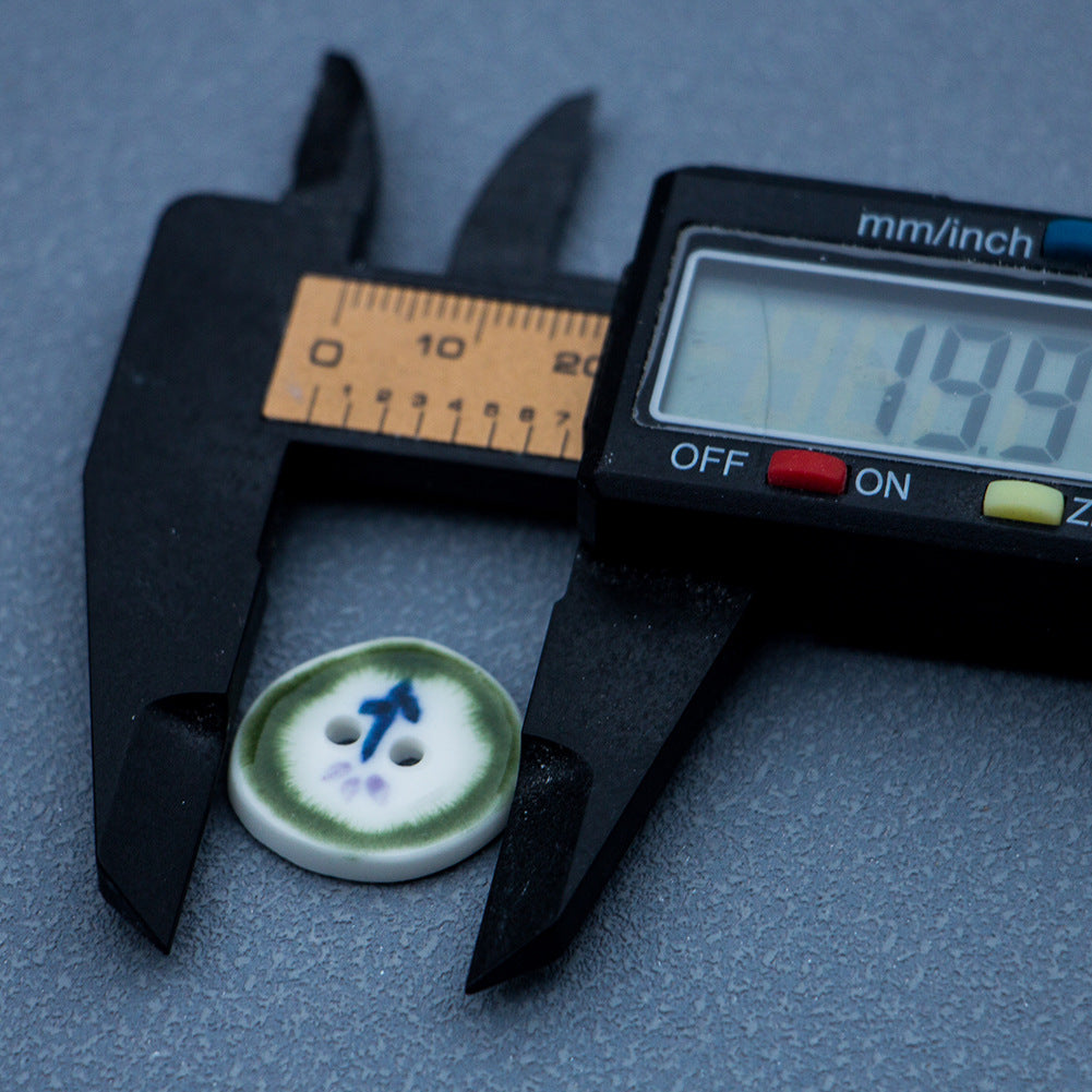20mm green ceramic button shown with measurement caliper; irregular round, blue/purple motif