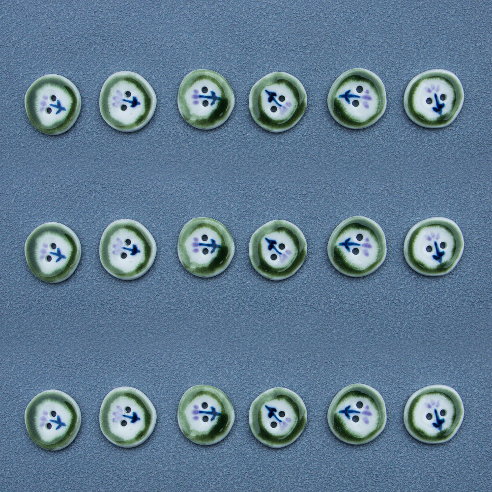 Multiple 20mm irregular round ceramic buttons, green rim, hand-painted blue/purple design