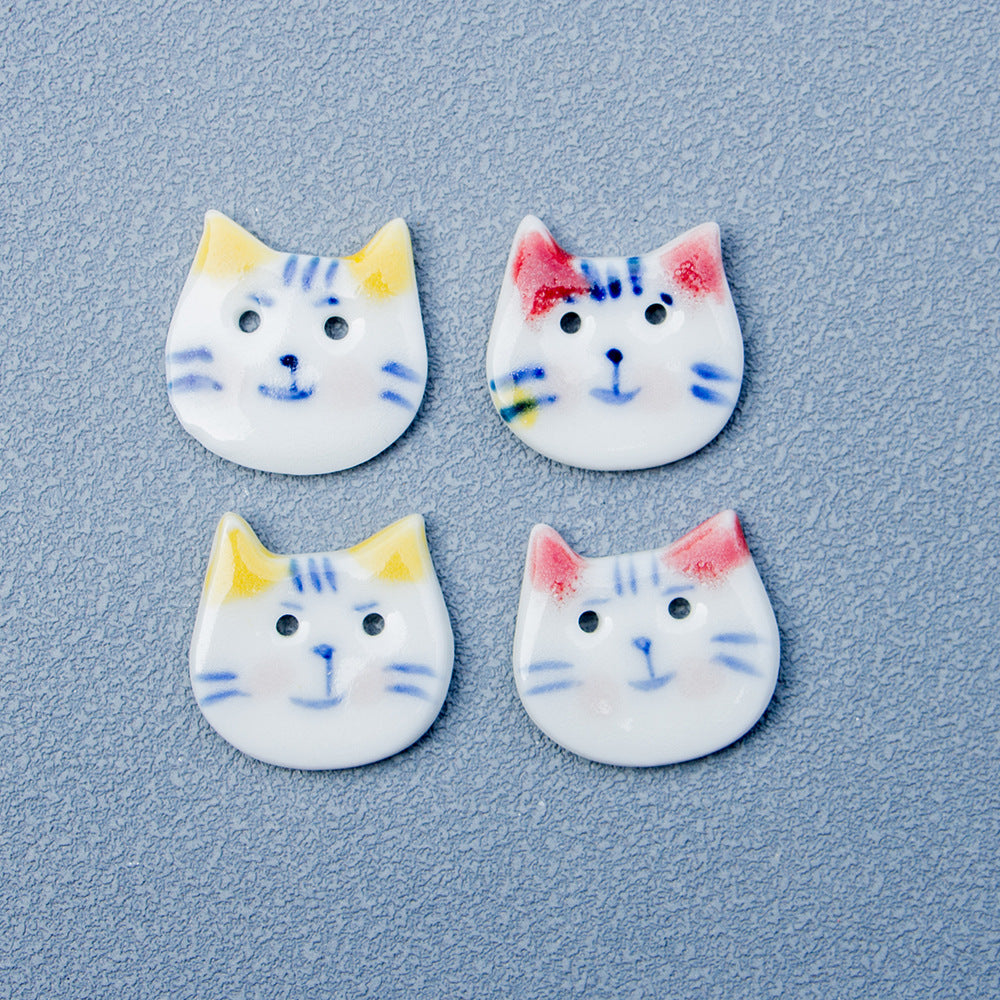 Set of blue-and-white cat ceramic buttons: yellow-ear and red-ear faces