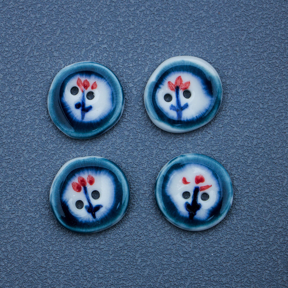 Four dark blue ceramic buttons with hand-painted red flower motif, round 2-hole