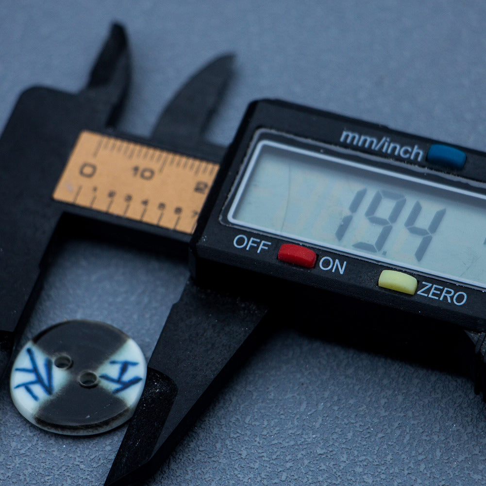 20mm ceramic button with blue lattice on dark face, two-hole, measured with caliper